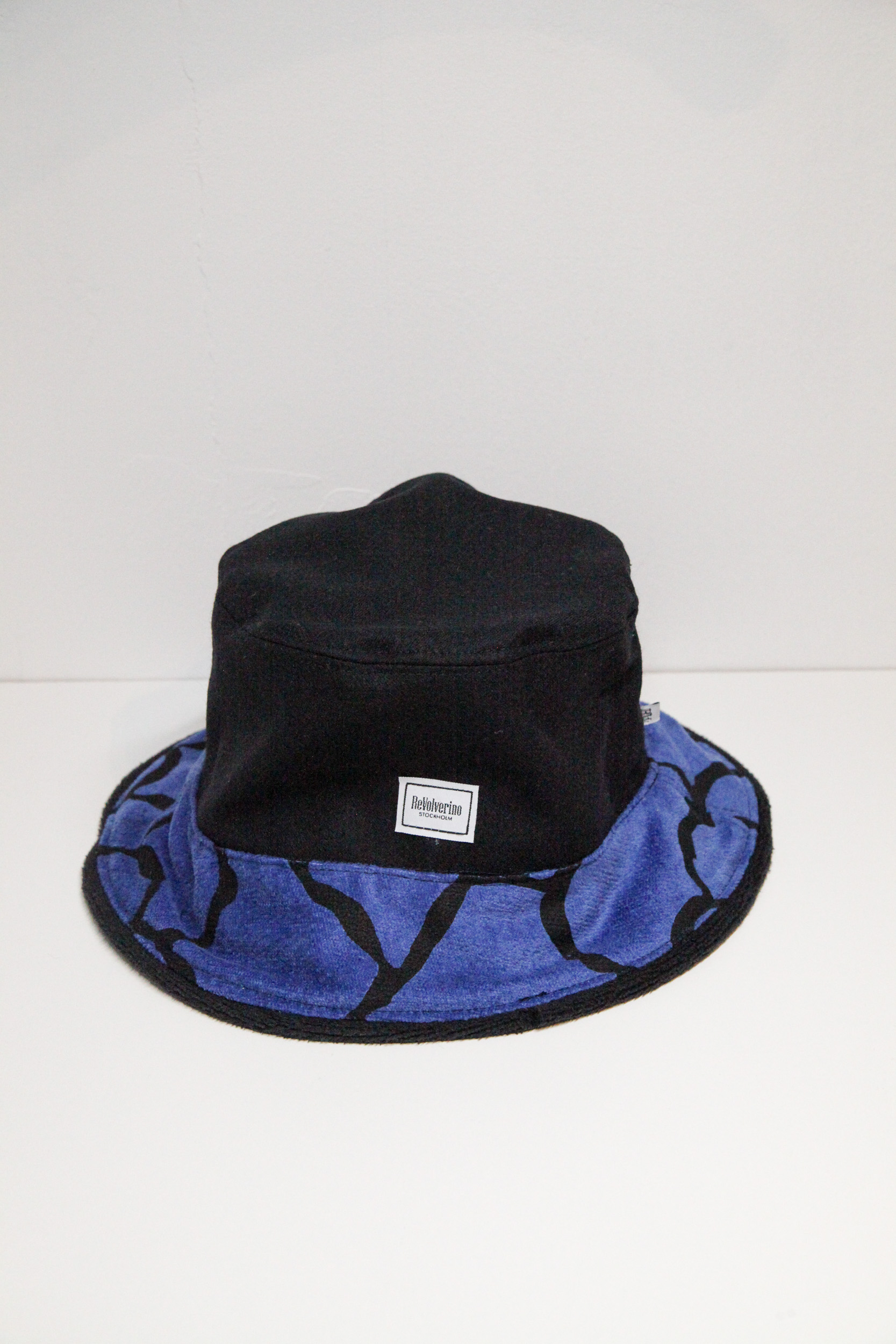 Unique black bucket hat with black and blue pattern on the visor.