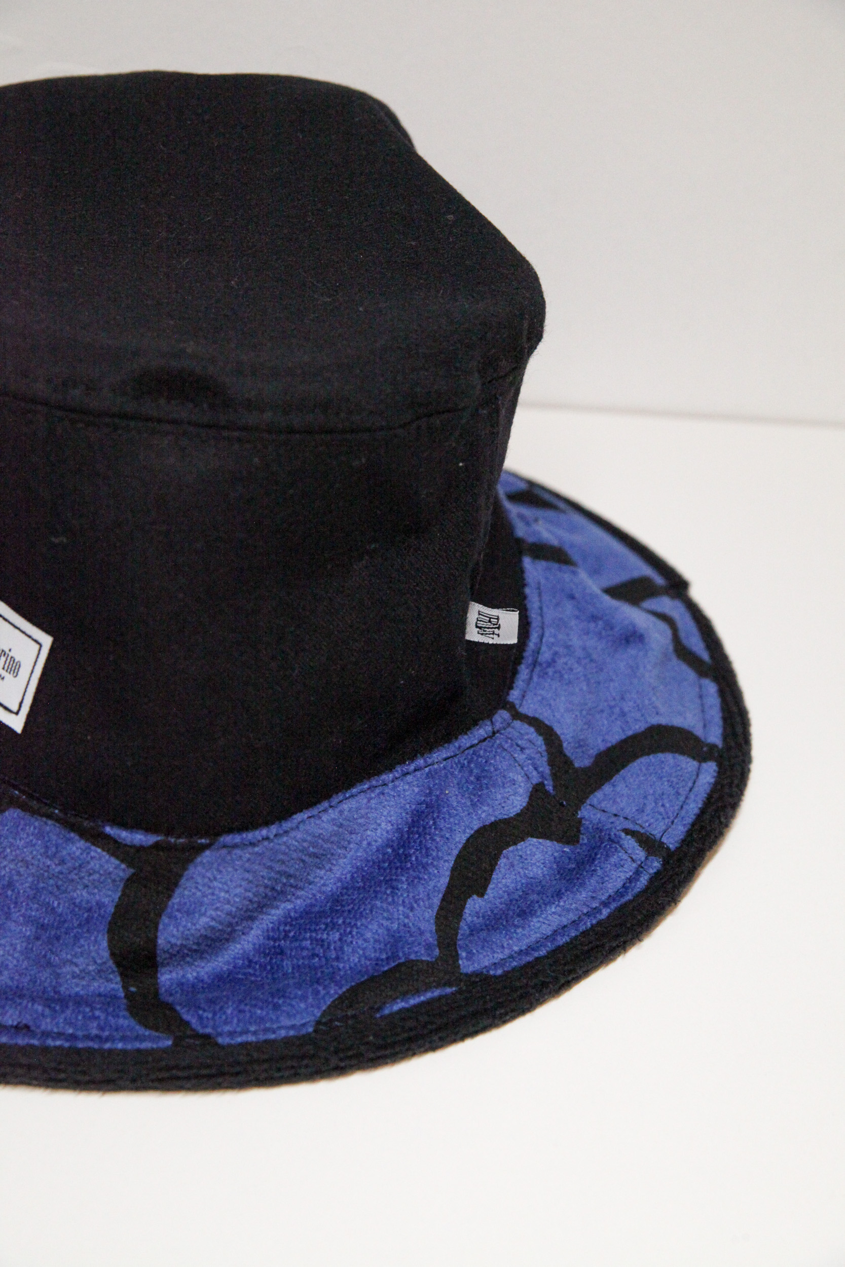 Unique black bucket hat with black and blue pattern on the visor.