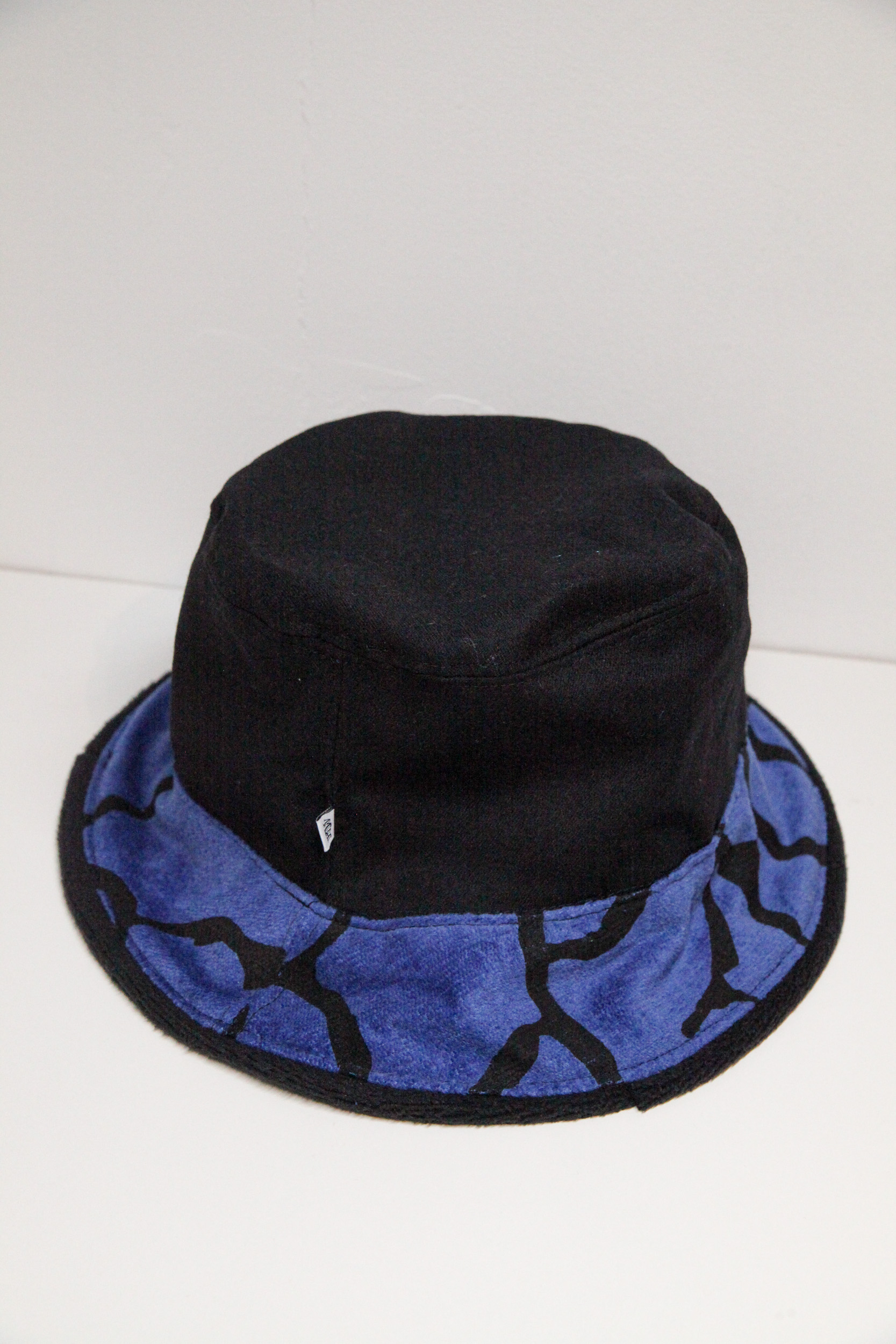 Unique black bucket hat with black and blue pattern on the visor.