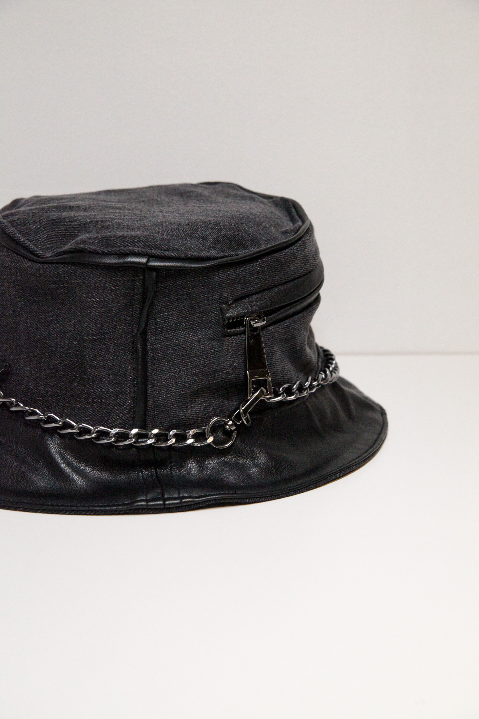 Black and grey bucket hat with chain and pocket on front