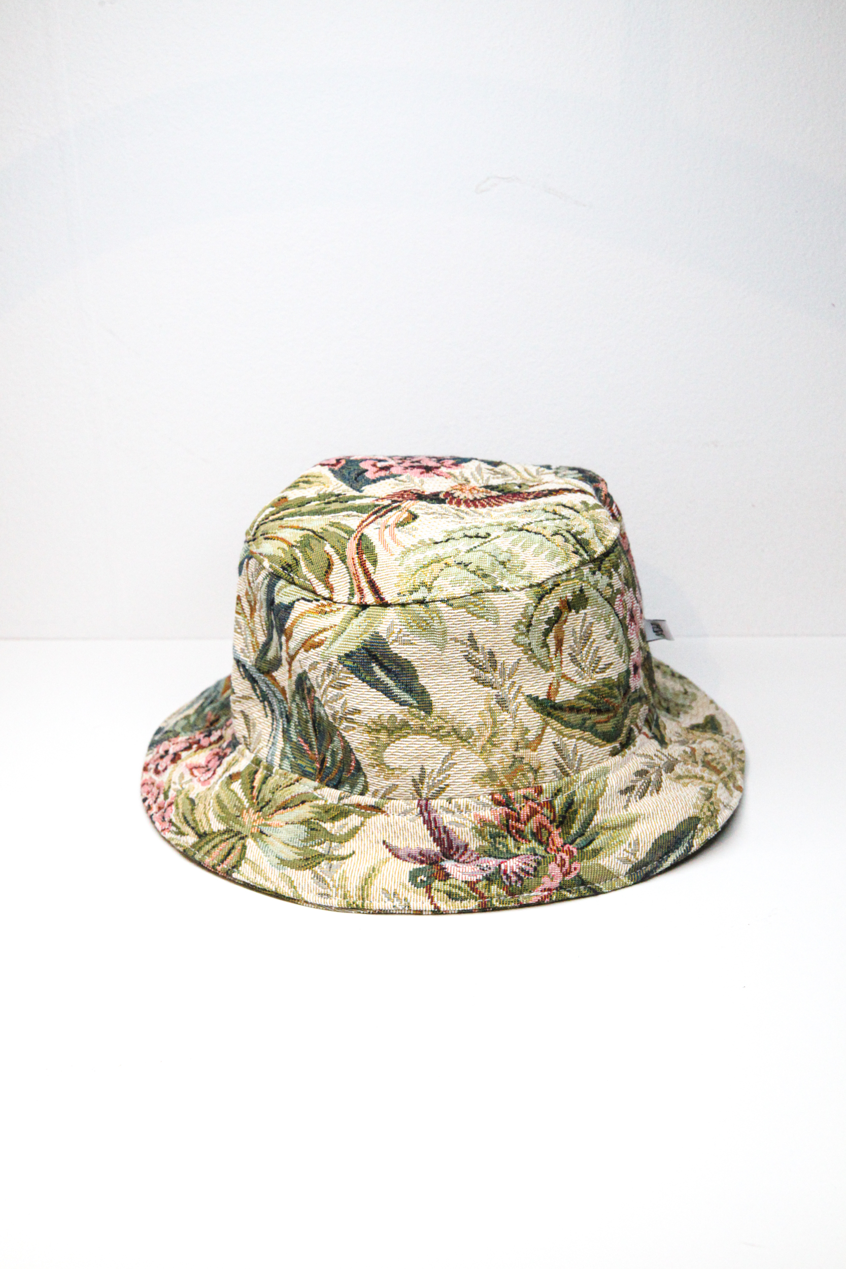 Green bucket hat with tropical flower pattern and exotic birds