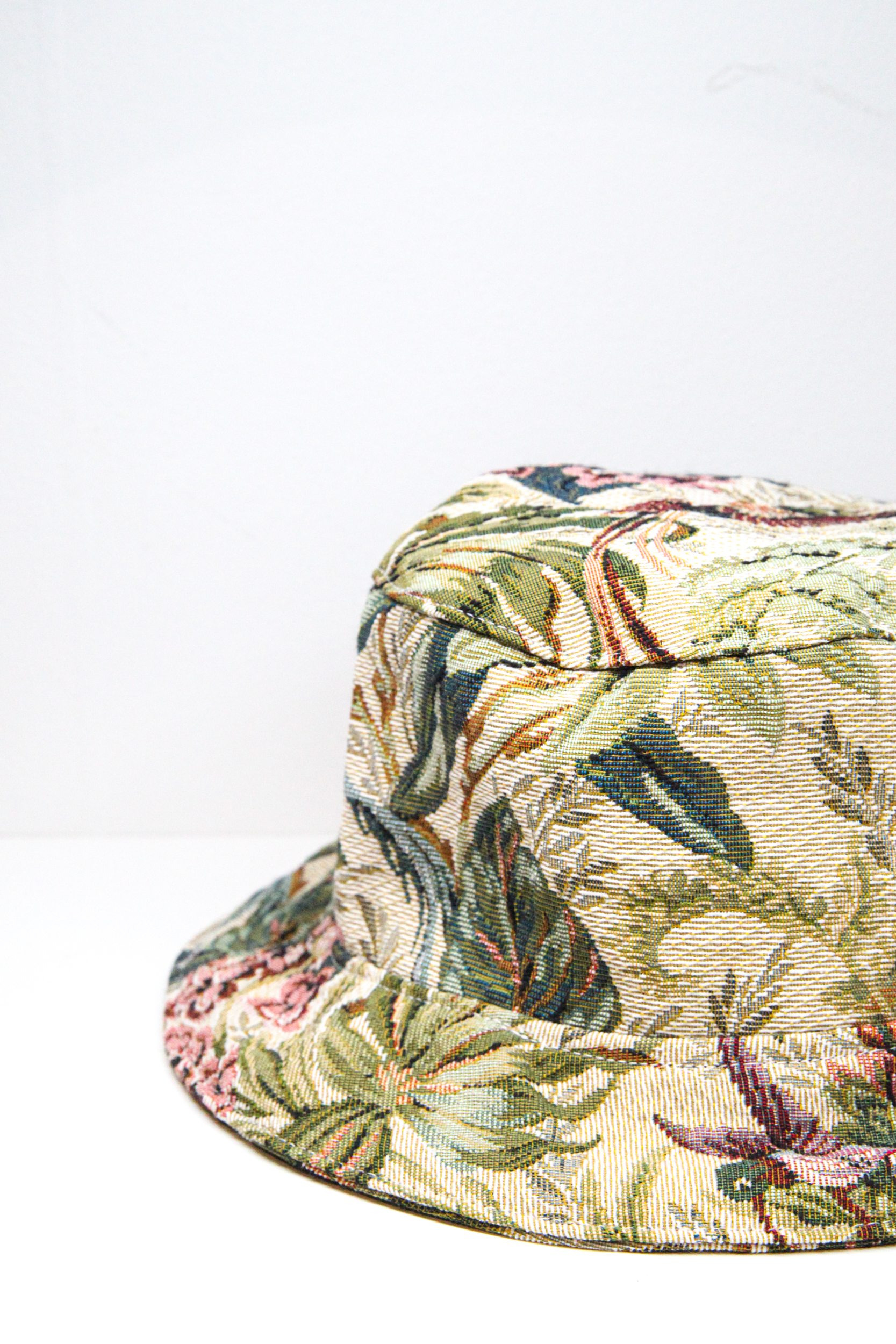 Green bucket hat with tropical flower pattern and exotic birds