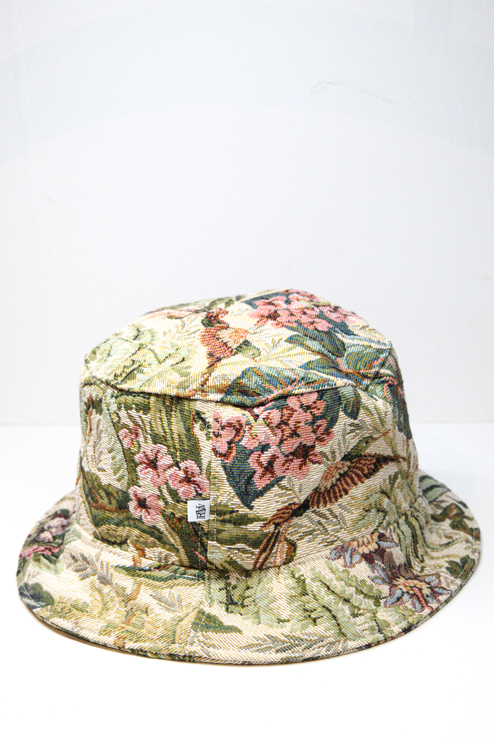 Green bucket hat with tropical flower pattern and exotic birds