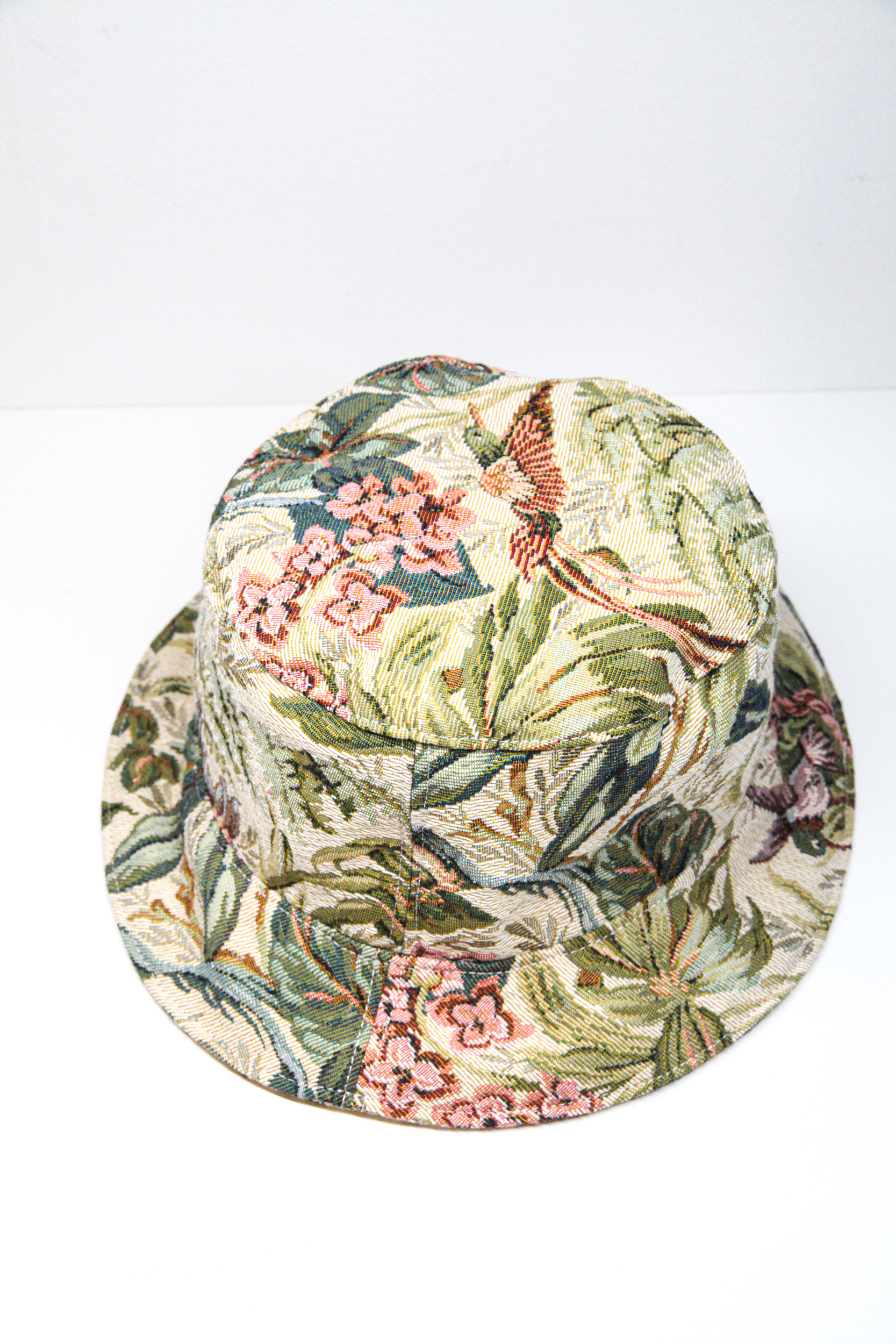 Green bucket hat with tropical flower pattern and exotic birds