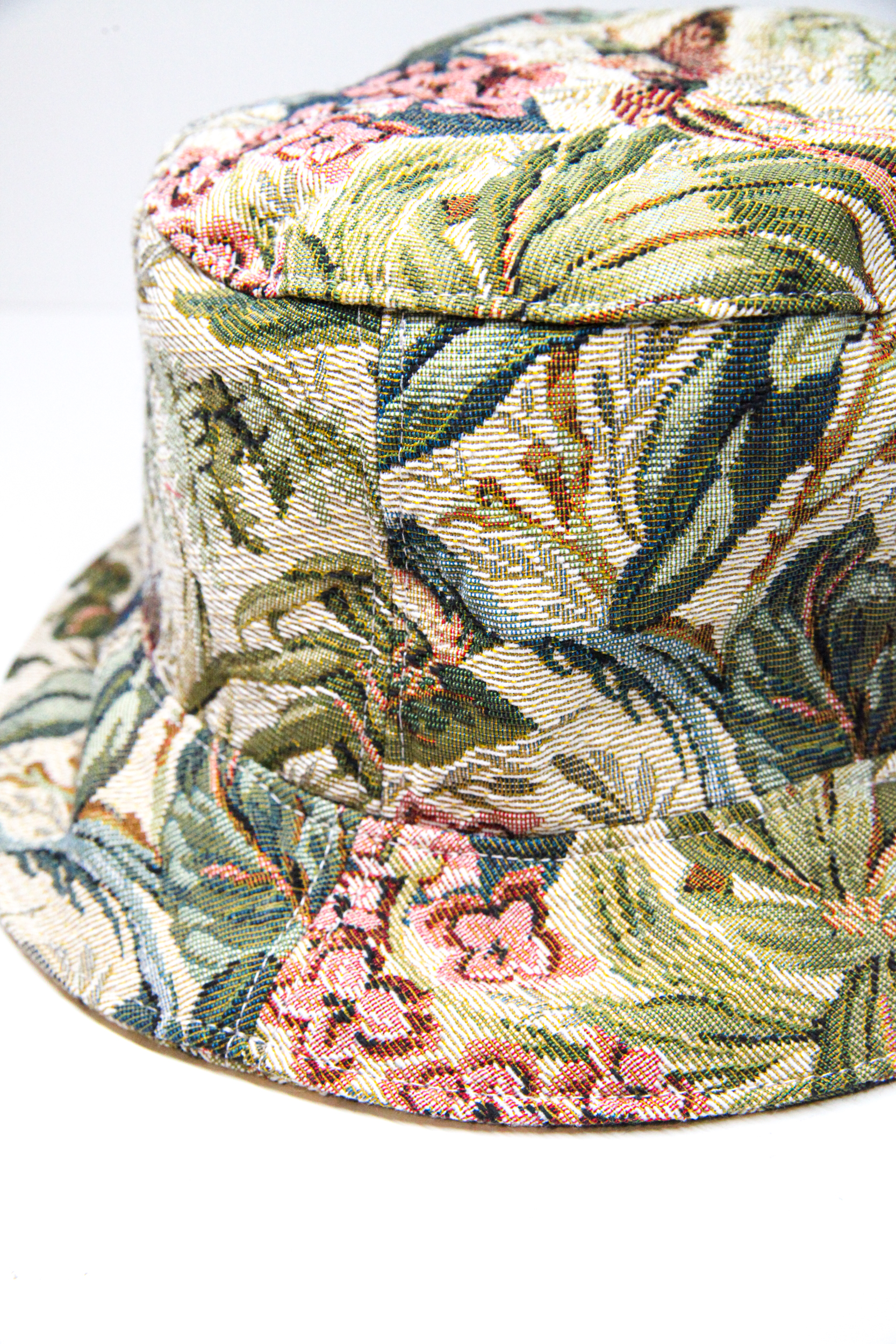 Green bucket hat with tropical flower pattern and exotic birds