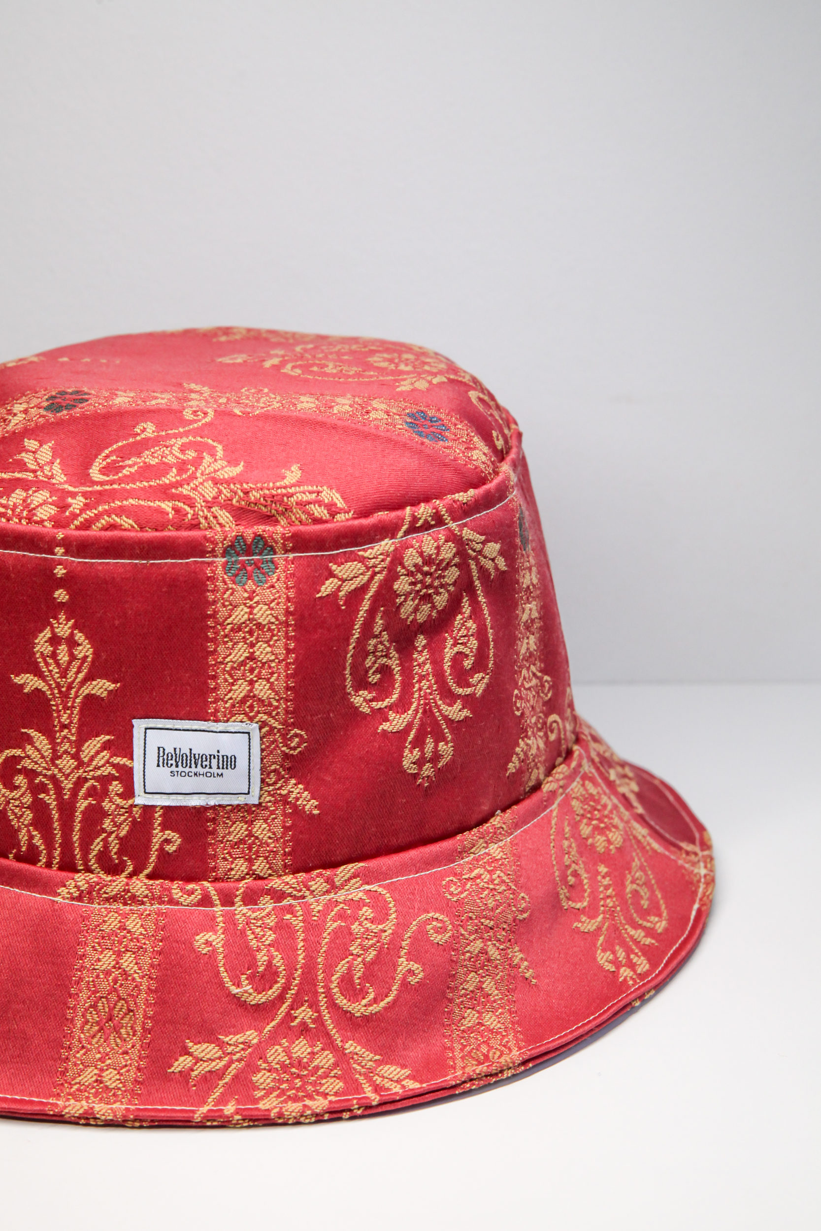 Red classical bucket hat with golden stitched pattern