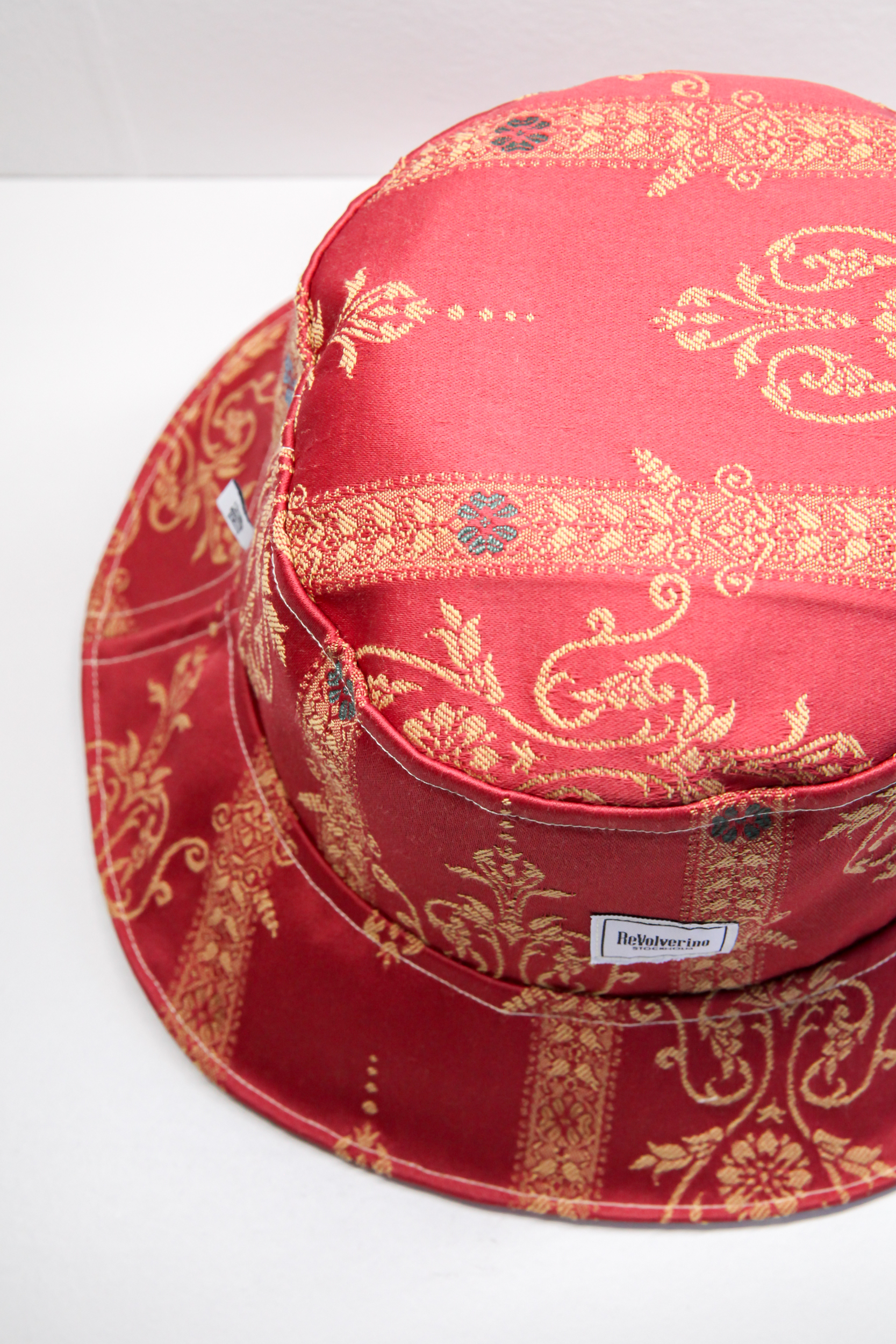 Red classical bucket hat with golden stitched pattern