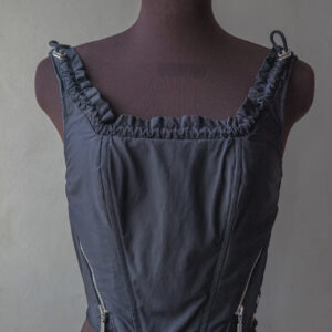 Upcycled corset top of polyester jacket with frilled neckline and sown in zippers